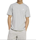Person wearing a gray Adidas t-shirt on a white background