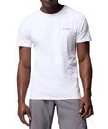 Man wearing a white t-shirt with a brand logo on a white background